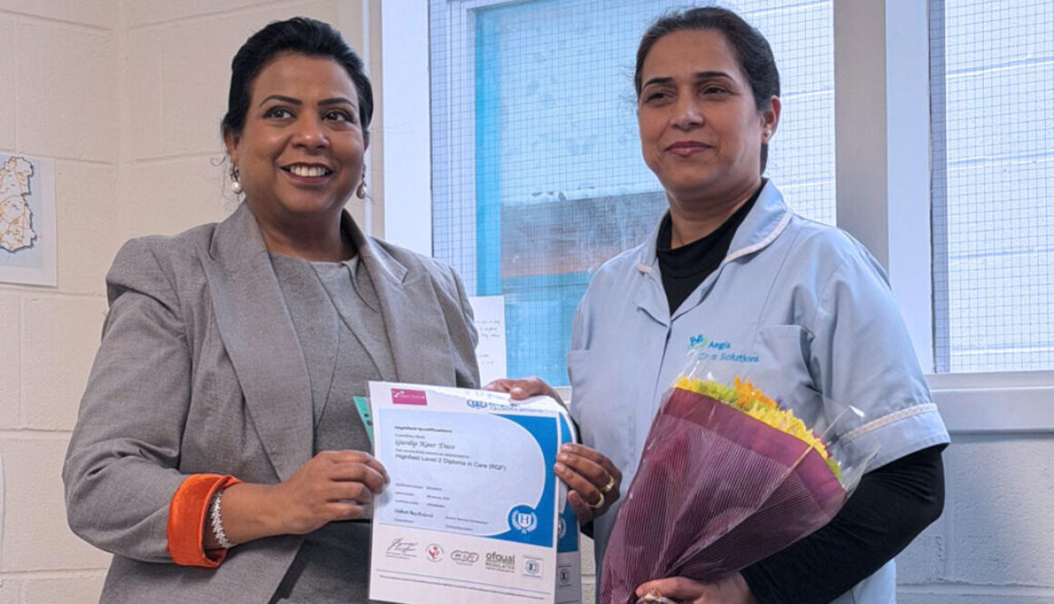 Gurdip Kaur Dass holding her NVQ Level 2 certificate at the Aegis Care Solutions training academy in Leeds.