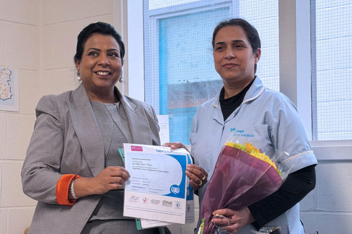 Gurdip Kaur Dass holding her NVQ Level 2 certificate at the Aegis Care Solutions training academy in Leeds.
