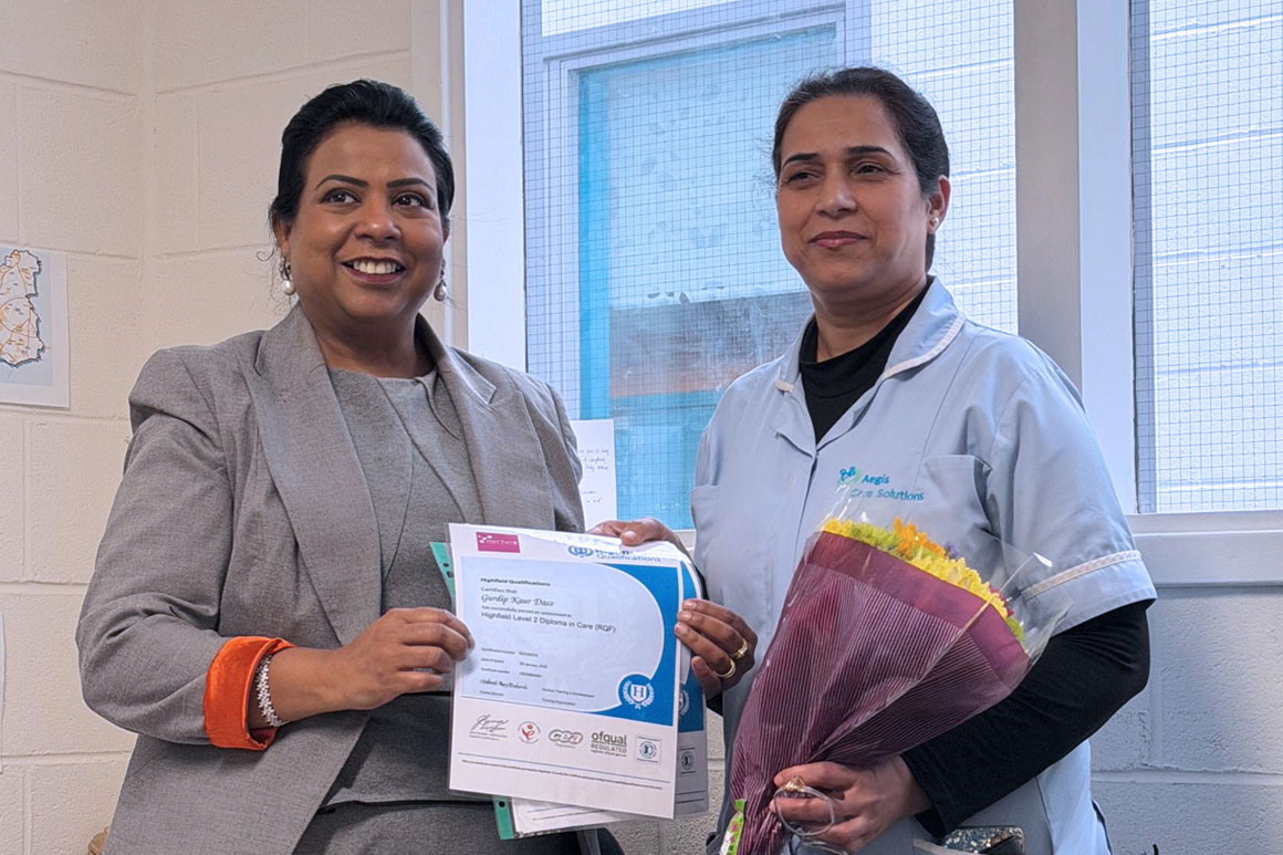 Gurdip Kaur Dass holding her NVQ Level 2 certificate at the Aegis Care Solutions training academy in Leeds.